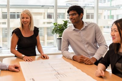 Office team at table discussing construction plans