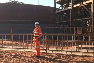 Construction worker standing in front of construction work